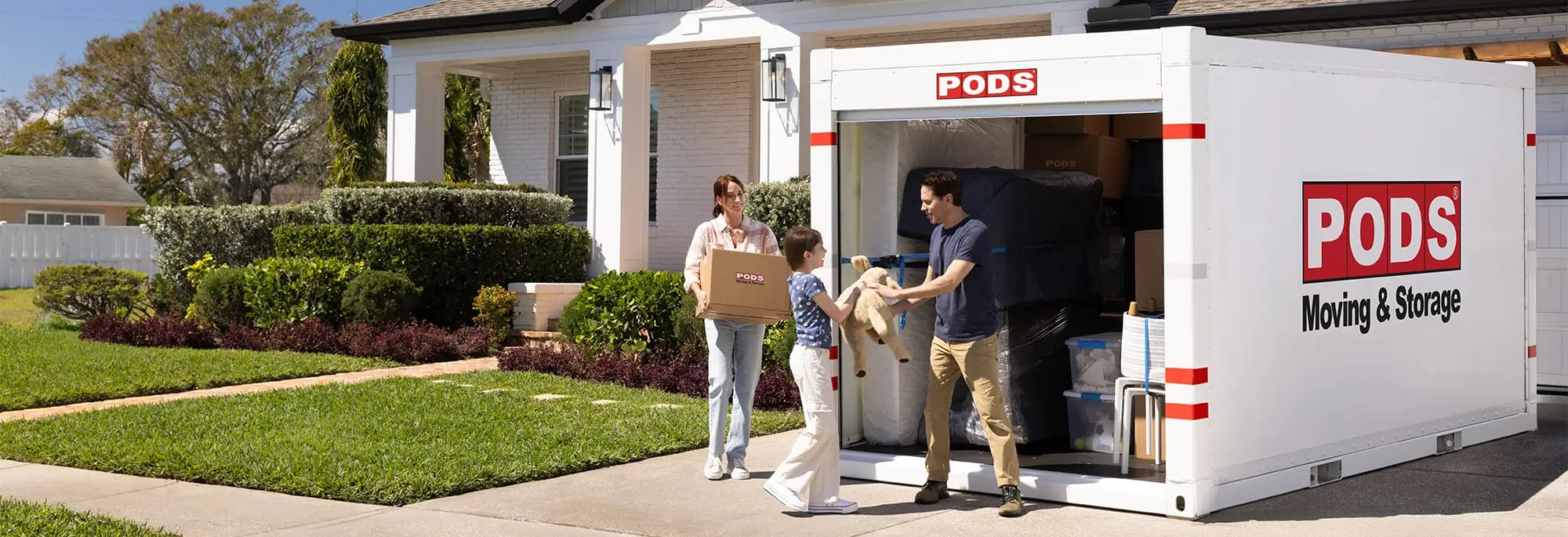 A family a PODS container in their driveway